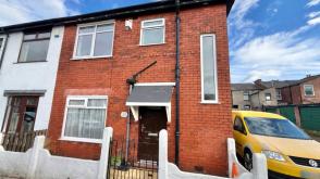 End-terraced property requiring modernisation in Denton photo
